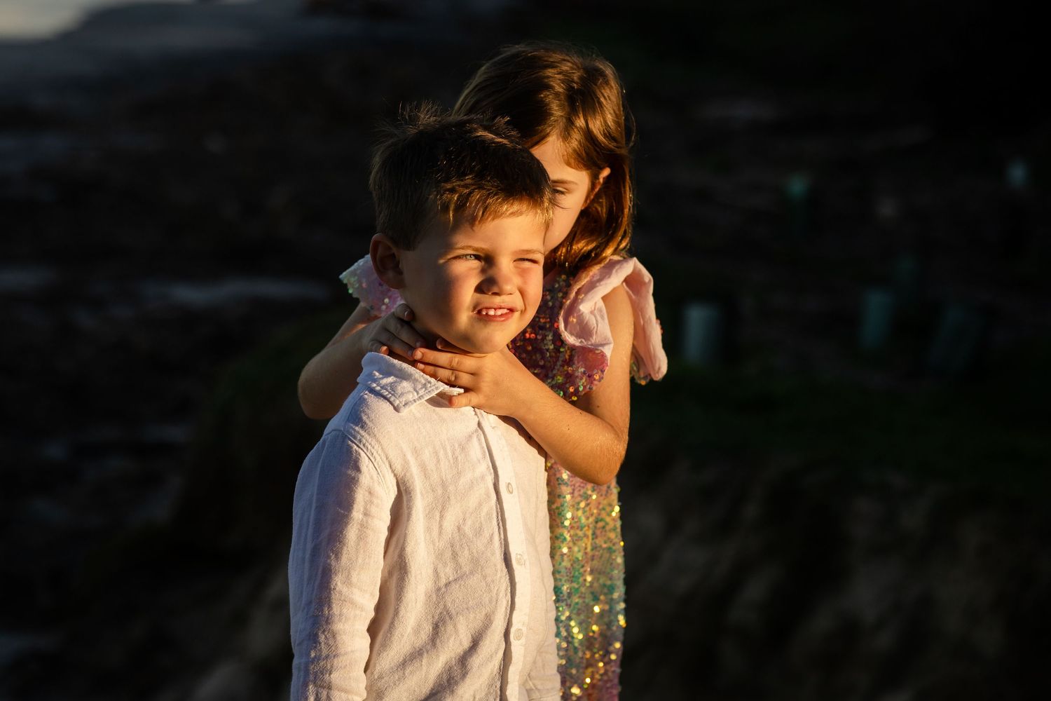 A sweet tender moment shared between family members at sunset on the beach.Family photography cabarita New South Wales Cabarita headland
