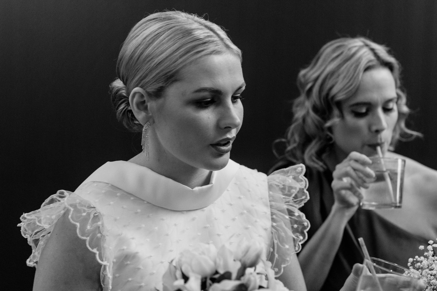 Elegant bride wearing vintage-inspired lace dress with ruffled collar.