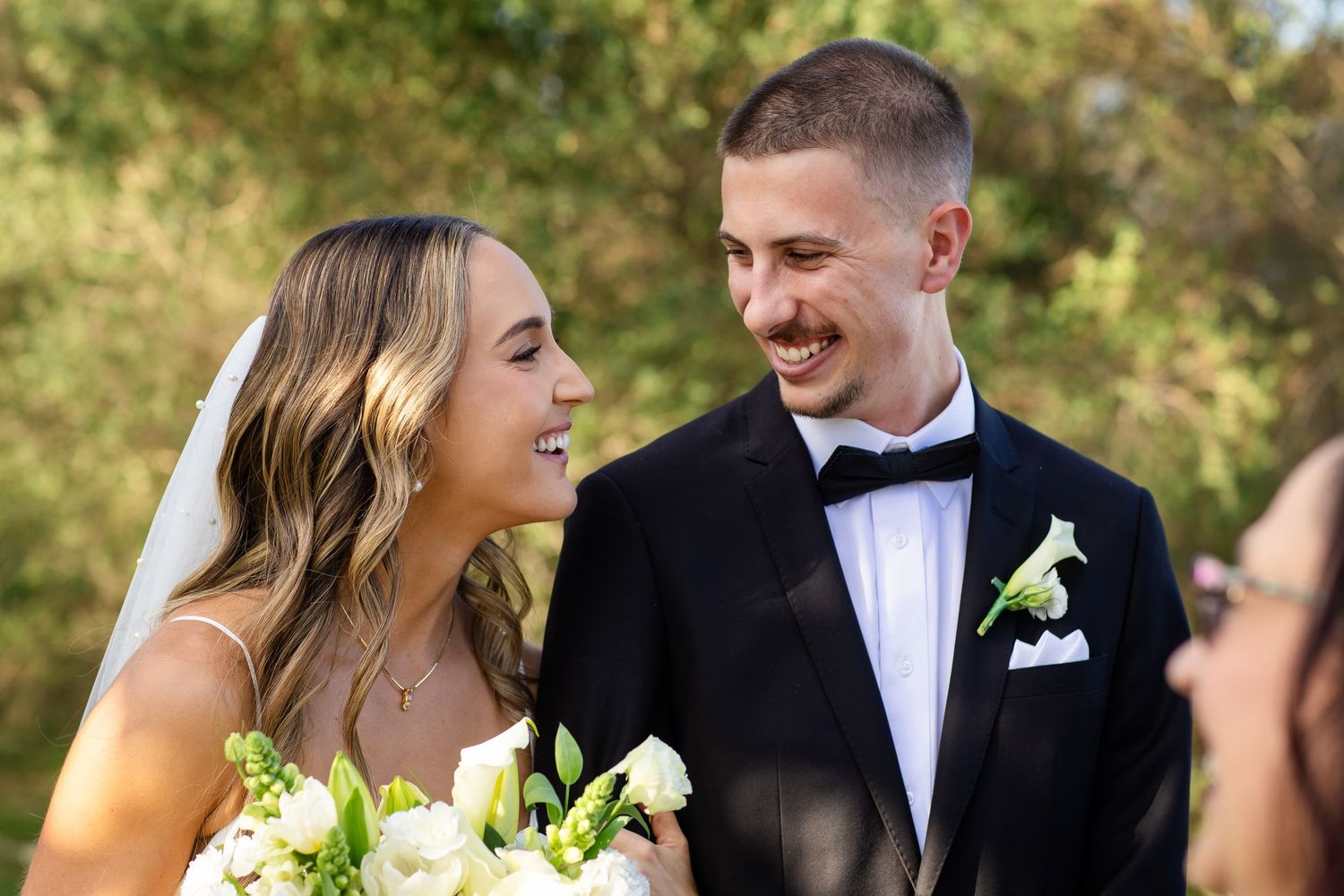 A wedding couple shares joyful moments together during their beach ceremony.beach wedding currumbin surf club wedding