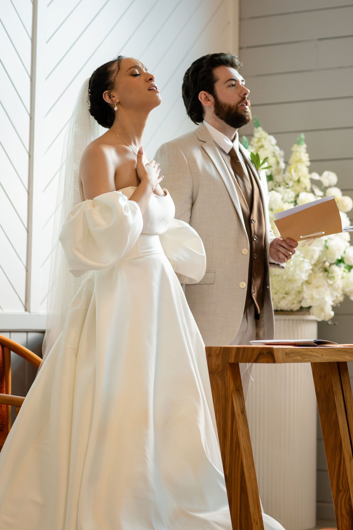 Series of candid wedding ceremony moments in a sunlit white chapel interior.The barrow restaurant mount Nathan wedding