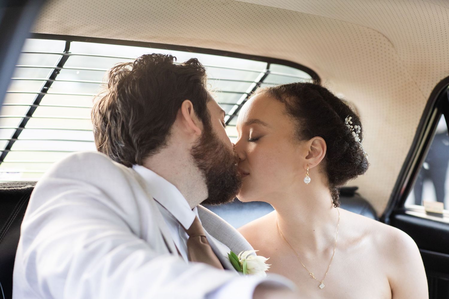 A romantic moment between newlyweds inside a classic car on their wedding day.The barrow restaurant mount Nathan wedding