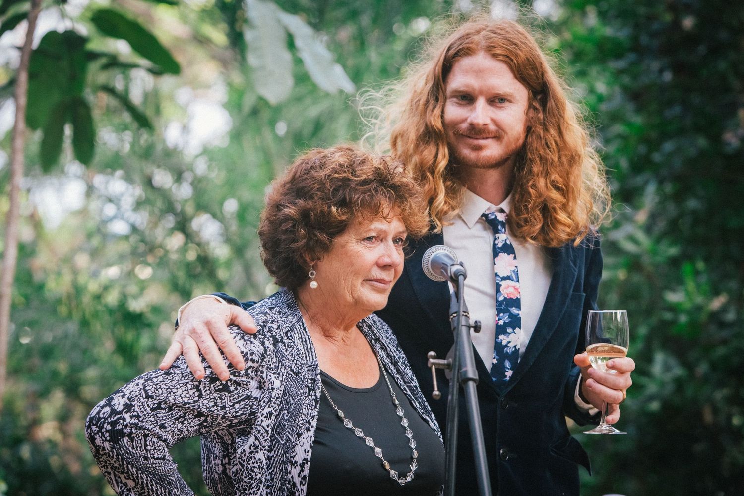 Guests sharing warm moments and laughter at an outdoor garden celebration.DIY wedding Gold Coast elopement photographer Gold Coast