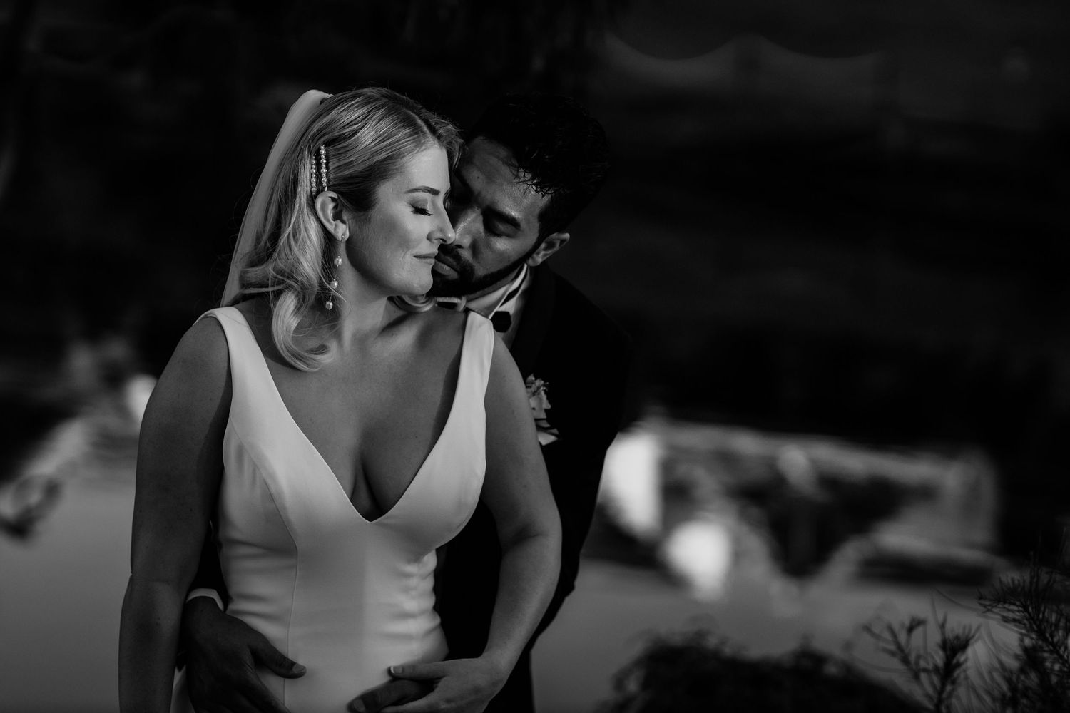 A romantic black and white photo shows a couple sharing an intimate moment during their wedding dance. Surfers Paradise Golf Club wedding.