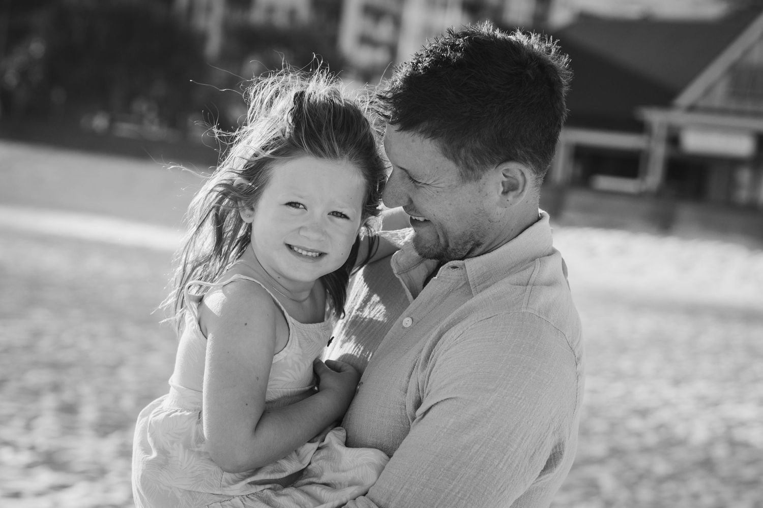 Intimate black and white portrait captured during a beach photoshoot.Gold Coast candid family photographer.