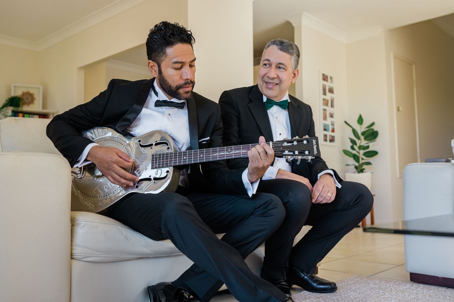 Two people in formal attire share playful moments while relaxing on a couch. Surfers Paradise Golf Club wedding. Surfers Paradise Golf Club