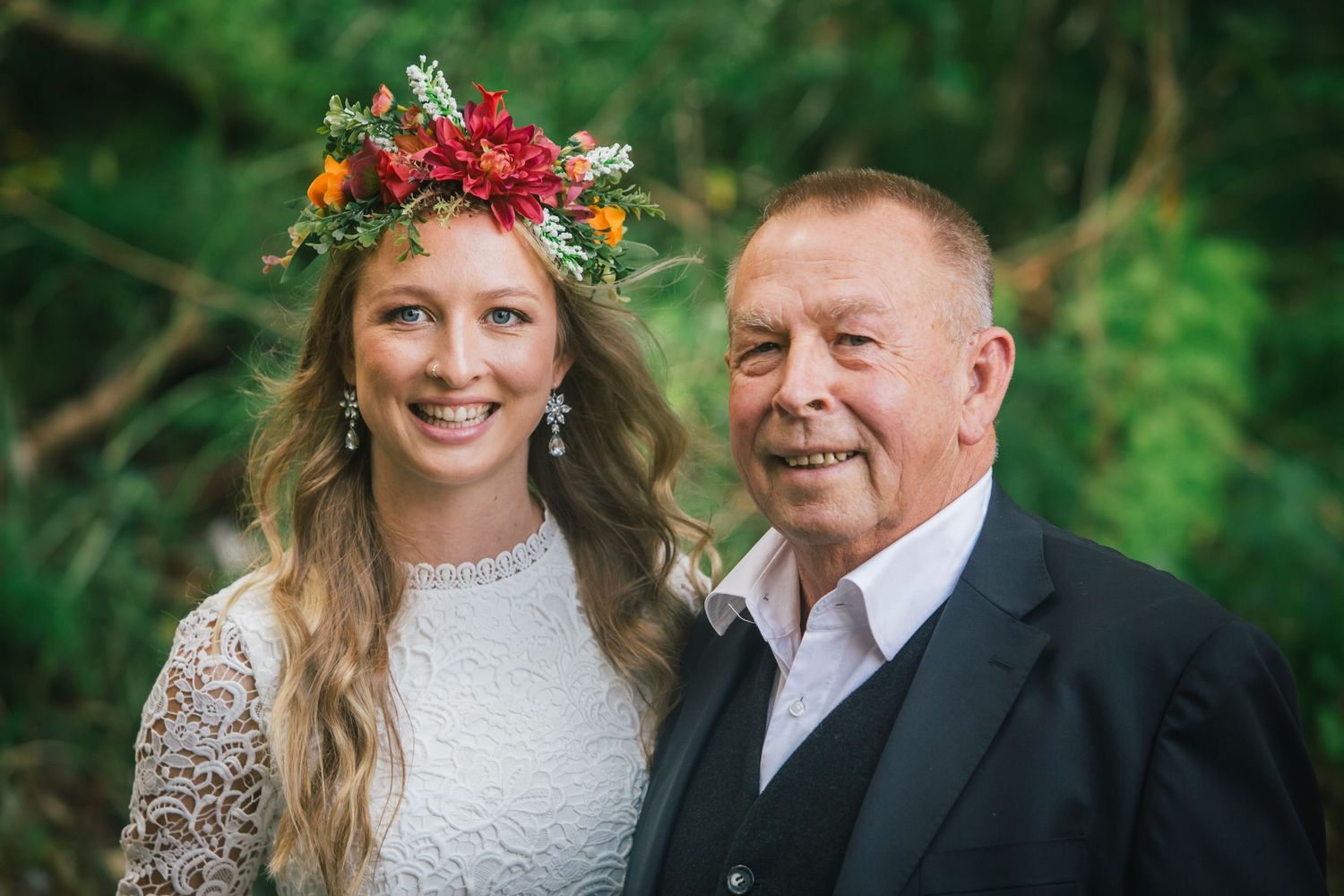 Outdoor wedding celebration with floral decorations and natural scenery.