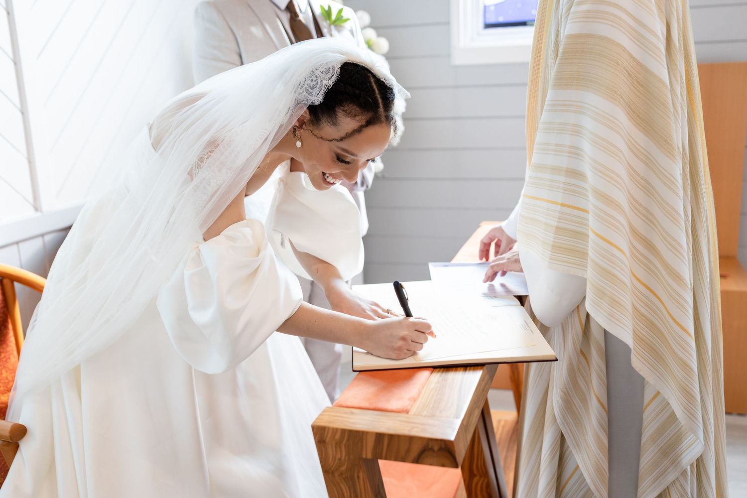 Wedding ceremony sequence showing intimate moments in a white chapel setting.The barrow restaurant mount Nathan wedding