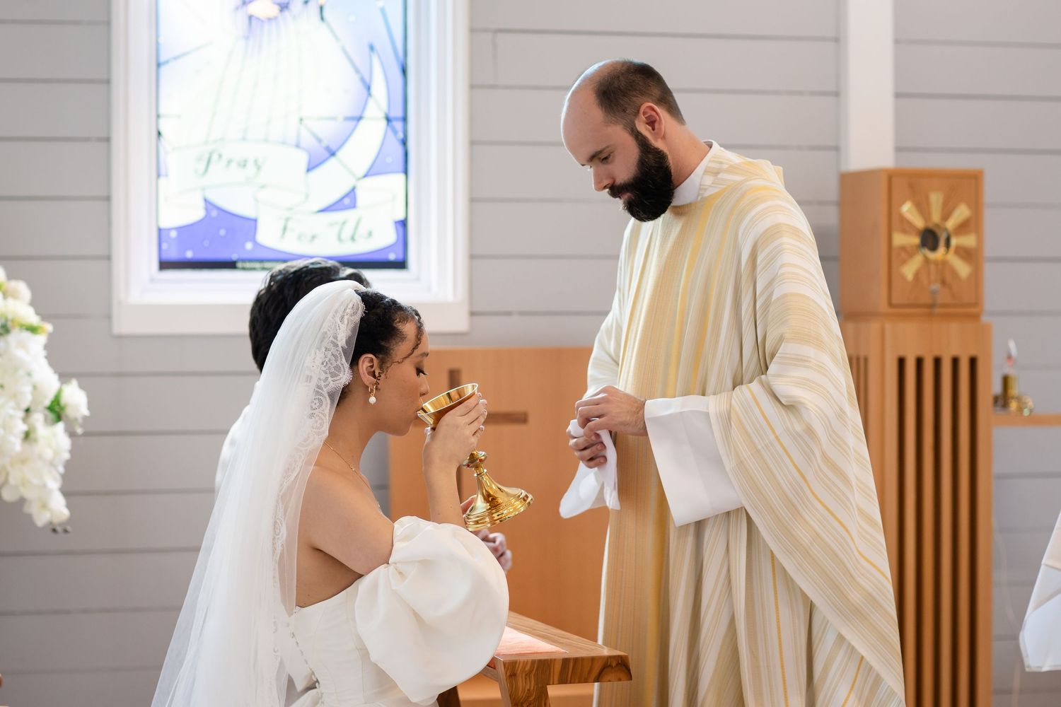 Wedding ceremony taking place in a light-filled chapel with white shiplap walls and wooden details.The barrow restaurant mount Nathan weddin