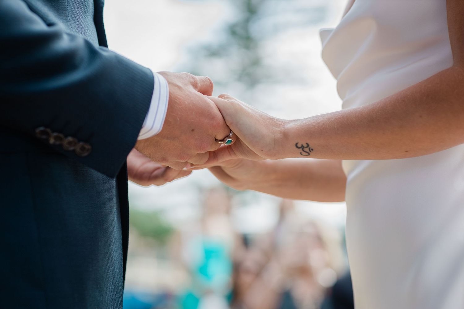Close-up of hands exchanging rings during wedding ceremony.Miami Burleigh heads beach wedding