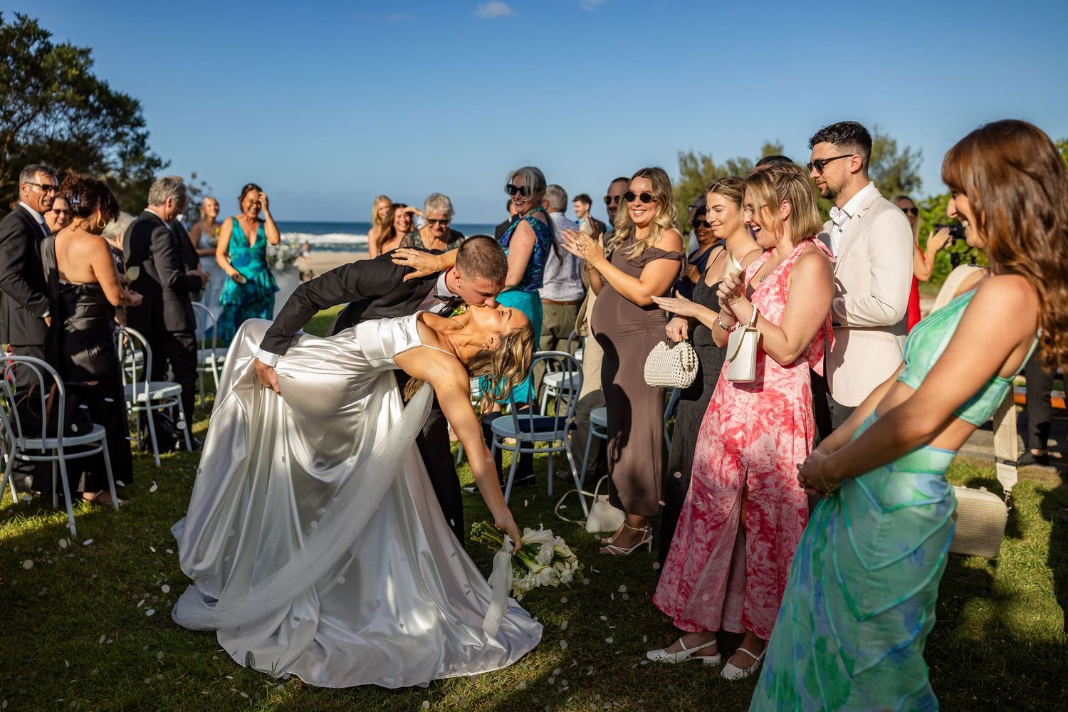 Wedding guests dance and celebrate at an outdoor reception by the ocean.beach wedding currumbin surf club wedding