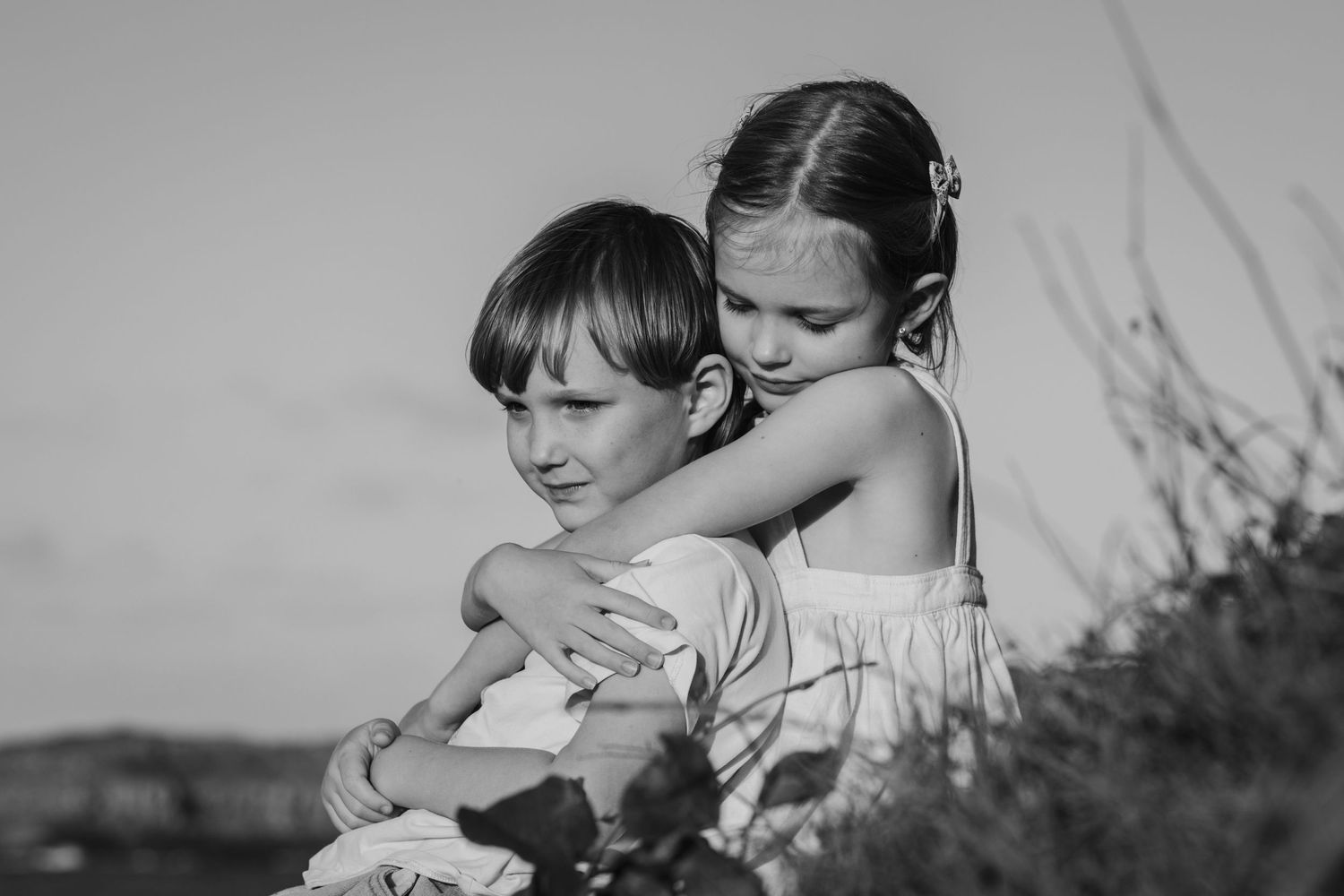 Black and white portrait of two dancers embracing in an intimate moment outdoors.Fingal head family photos -  New South Wales Gold Coast can
