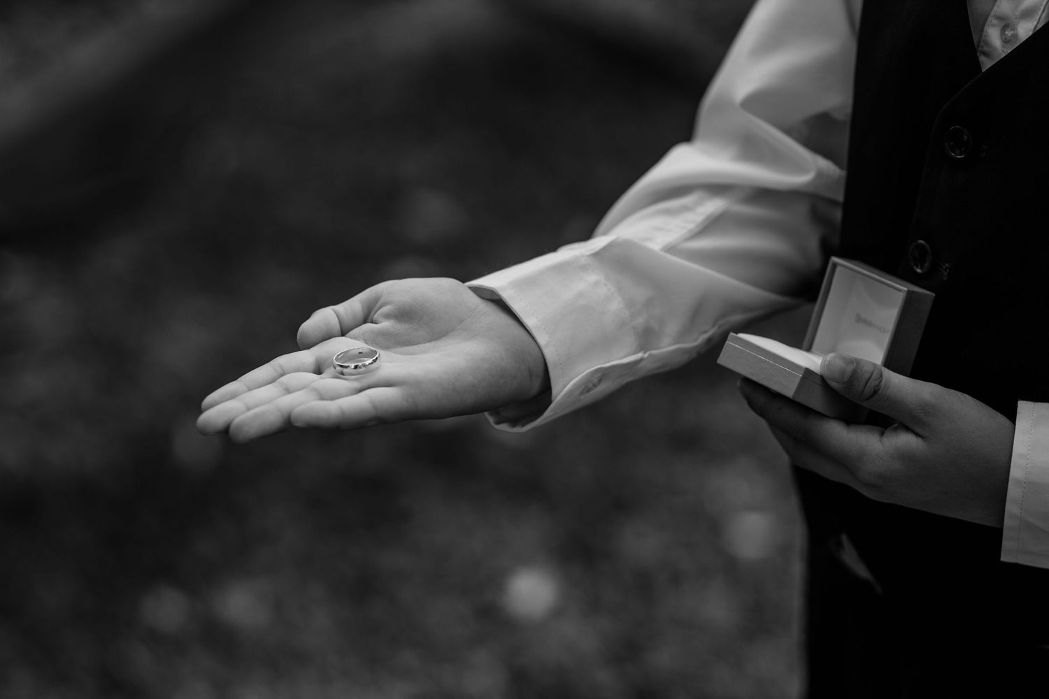 Black and white image of hands gesturing during an emotional wedding ceremony moment.Gold Coast beach wedding photography