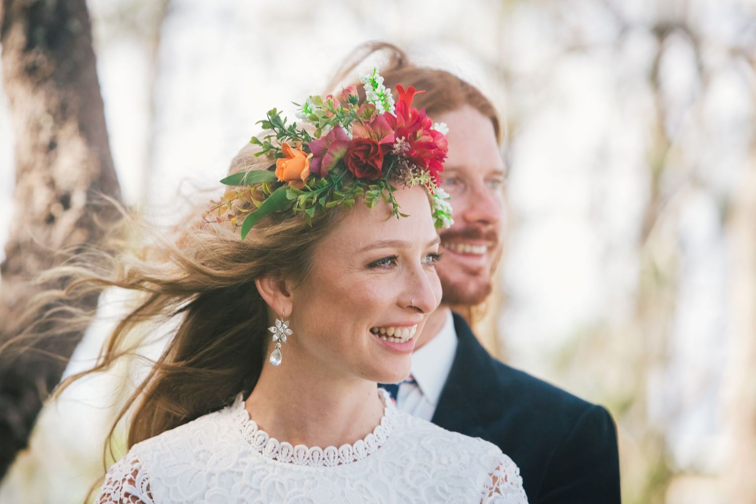 A joyful outdoor wedding portrait with colorful floral crown details.Tugun beach wedding Currumbin beach wedding
