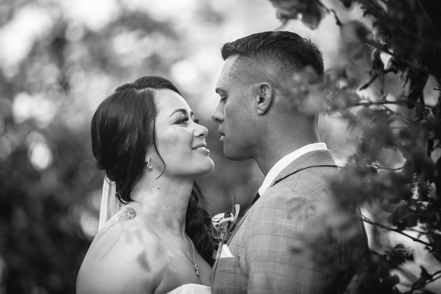 A black and white wedding portrait showing an intimate moment between a couple.candid wedding photography Gold Coast