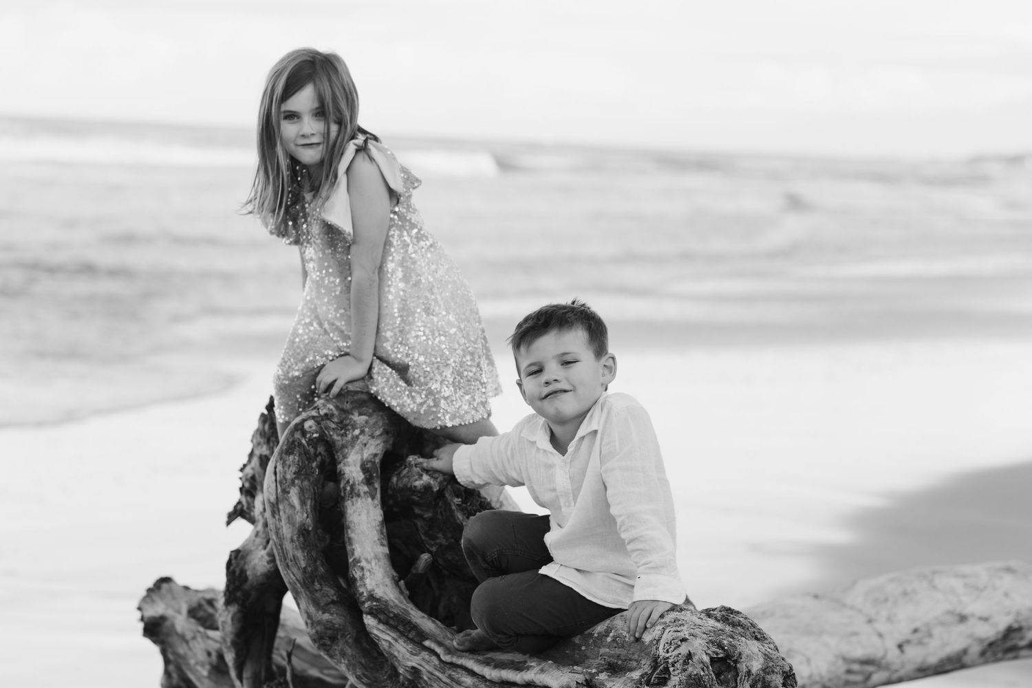 Family members relaxing together on a beach at sunsetFamily photography cabarita New South Wales Cabarita headland