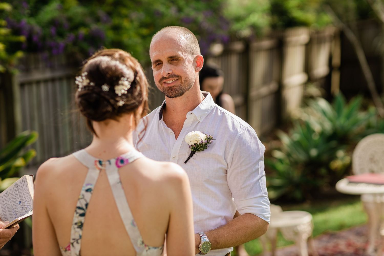 Wedding ceremony participants share a joyful moment in a garden setting.Gold Coast beach wedding photography