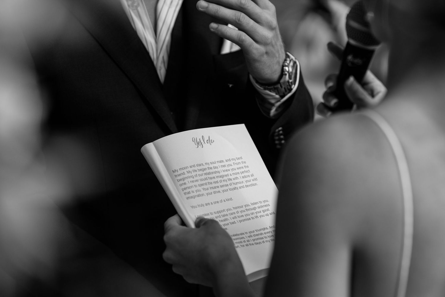Wedding ceremony attendees reading from program booklets during outdoor service.Miami Burleigh heads beach wedding