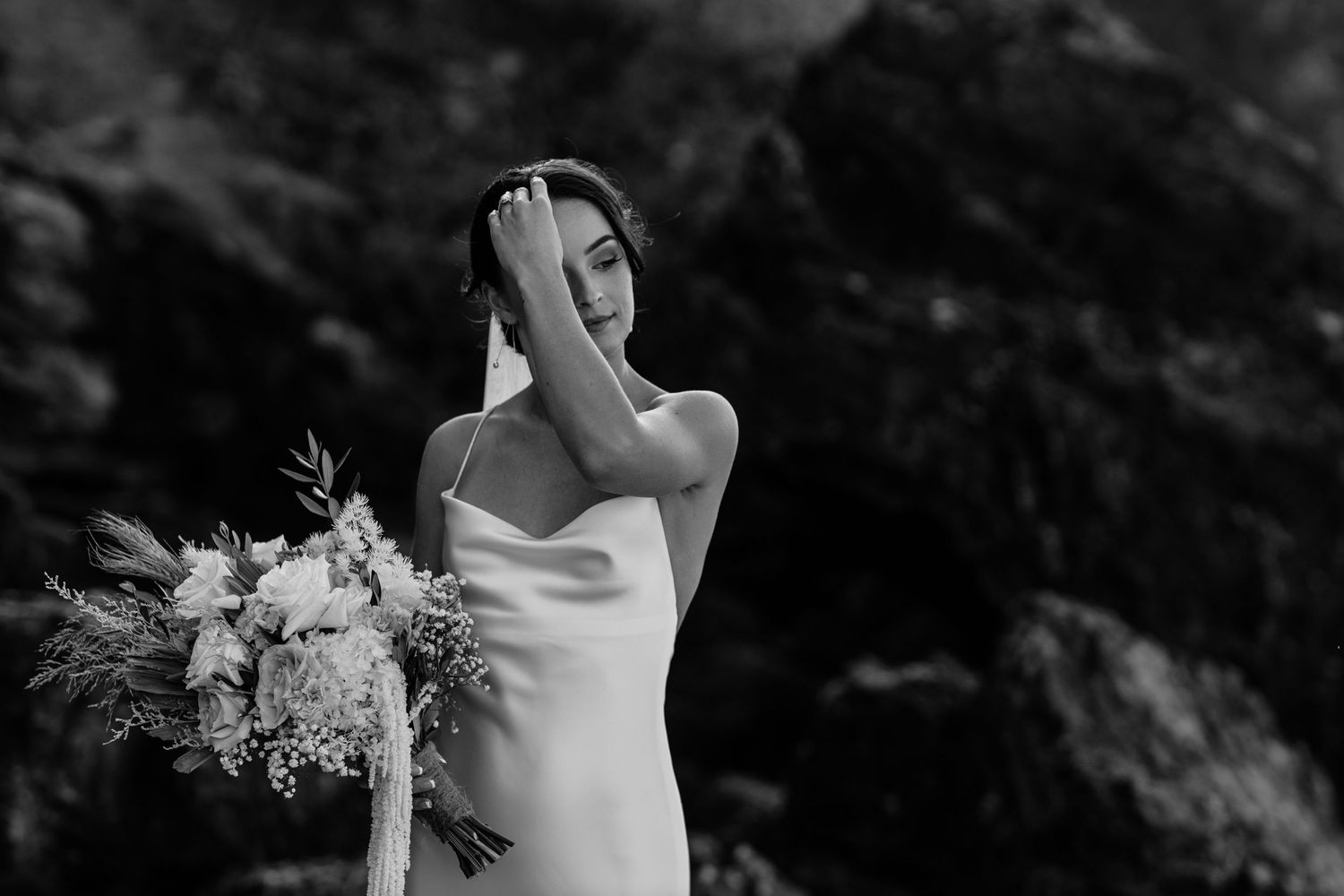 Black and white wedding portraits with dramatic rocky backdrop.Miami Burleigh heads beach wedding