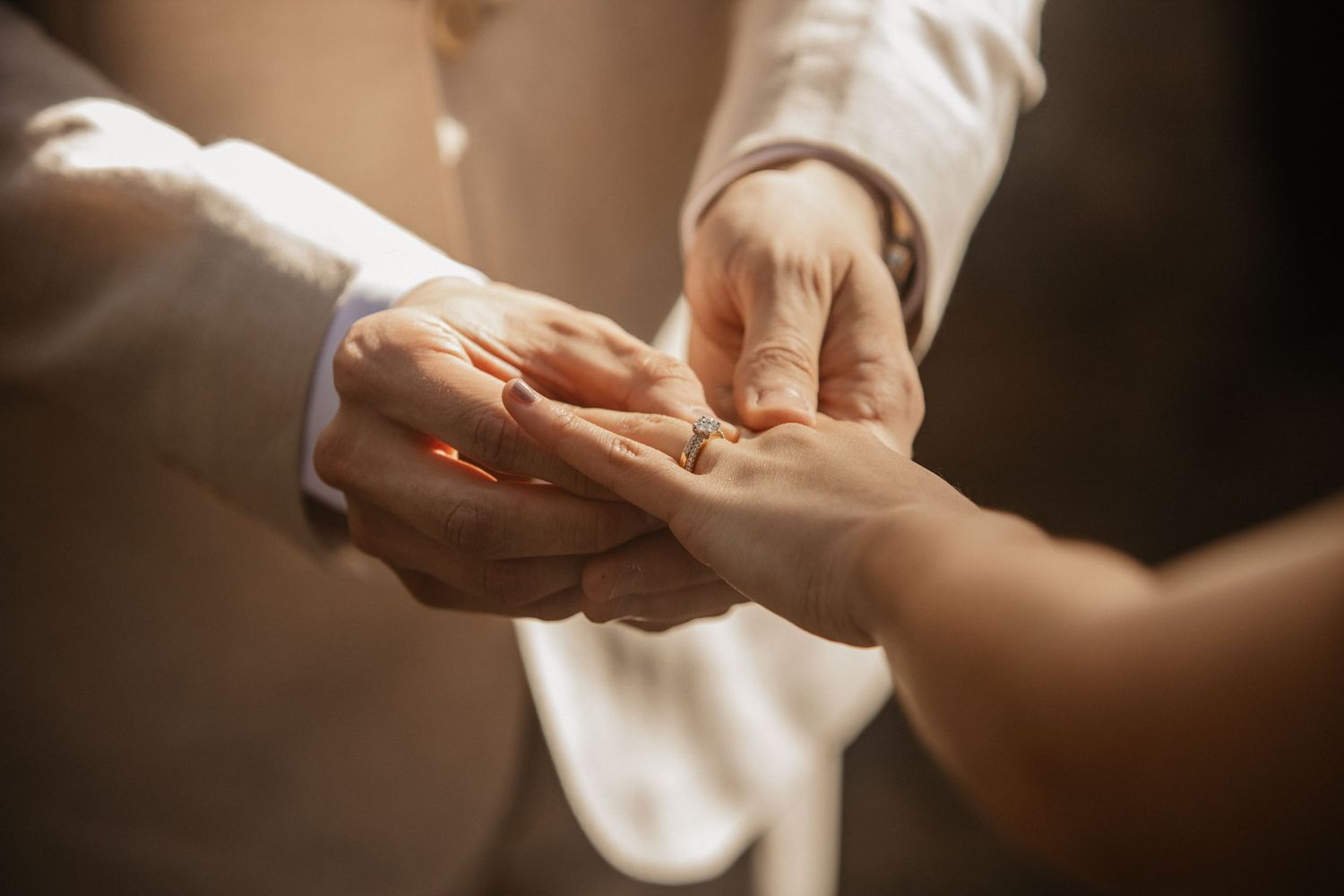 Close-up of hands exchanging rings during an intimate wedding ceremony.pizzey park wedding Gold Coast