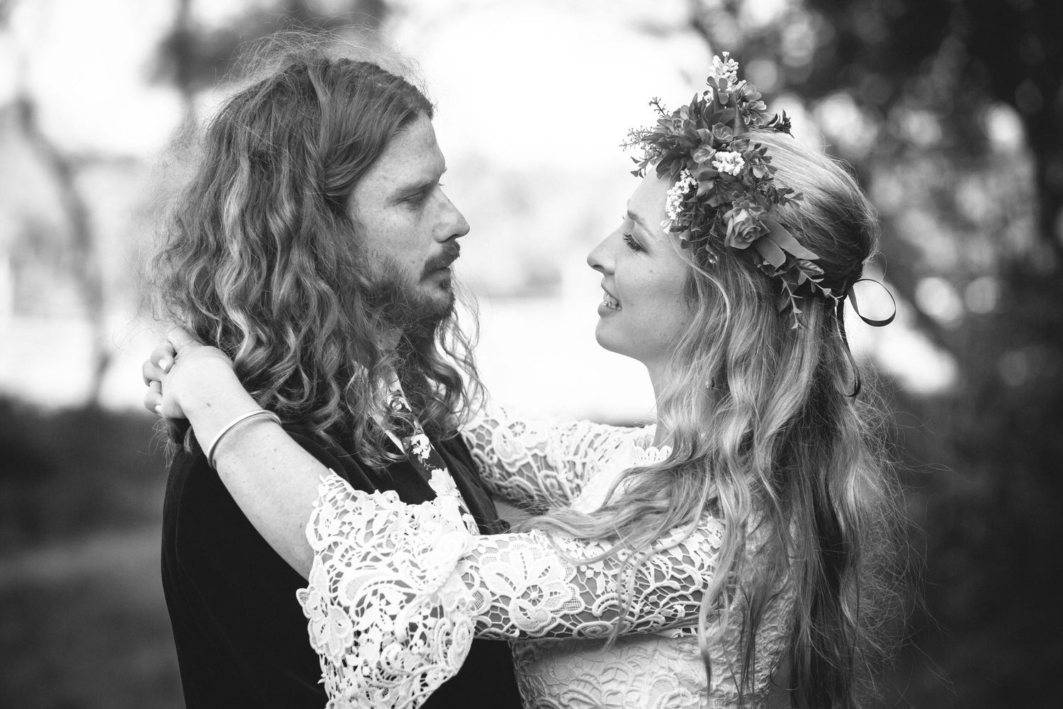 Black and white wedding photography showcasing intimate moments between a couple in nature.