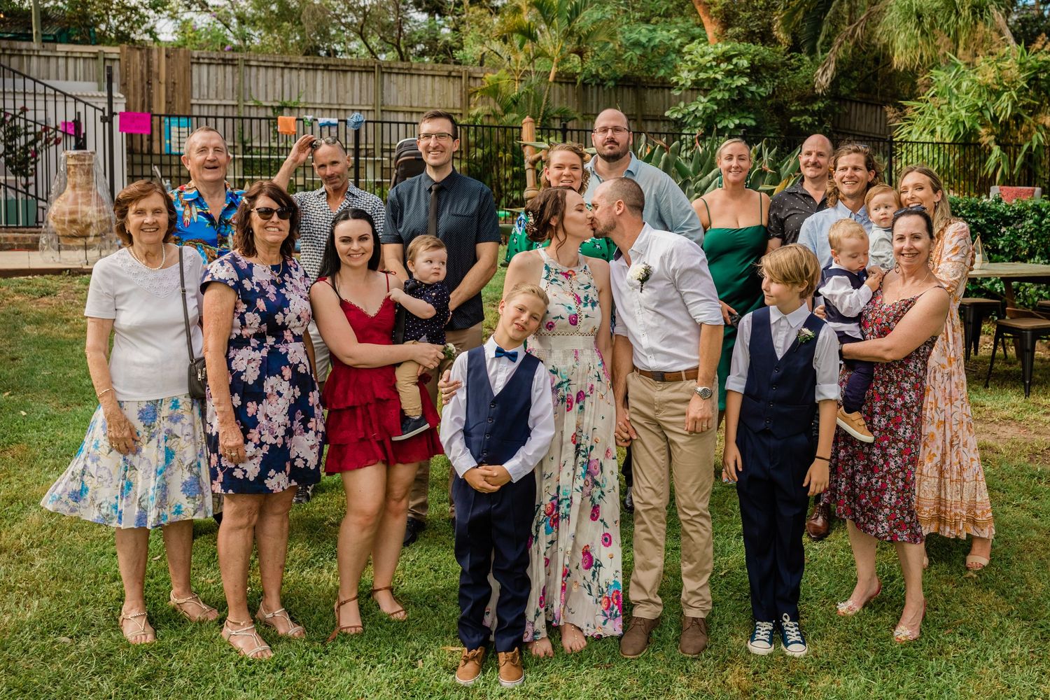 Large group photo of wedding guests gathered in a backyard garden setting.Gold Coast elopement photographer