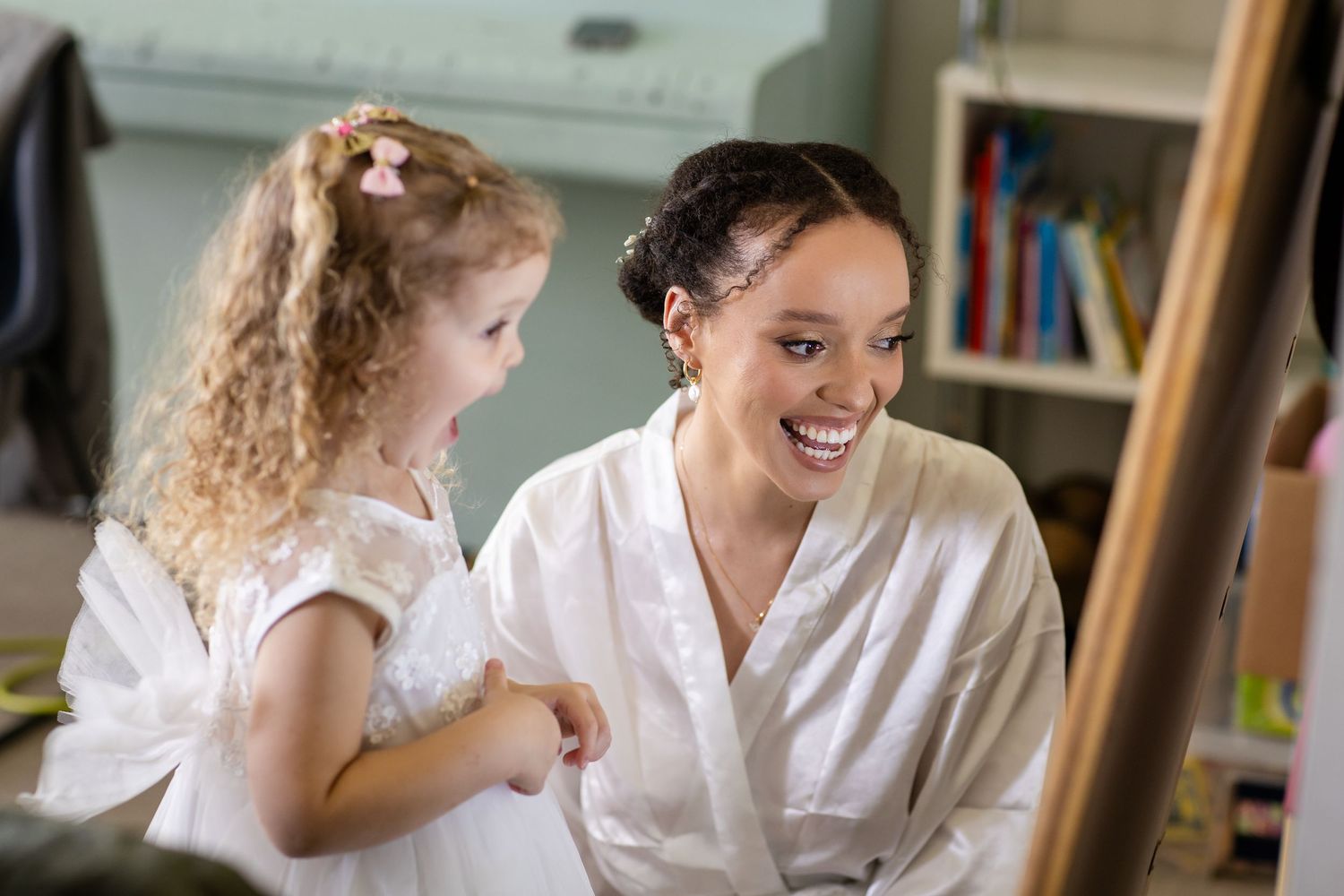 Candid laughter and joy during wedding day preparations in a bright room.Gold Coast hinterland wedding photographer