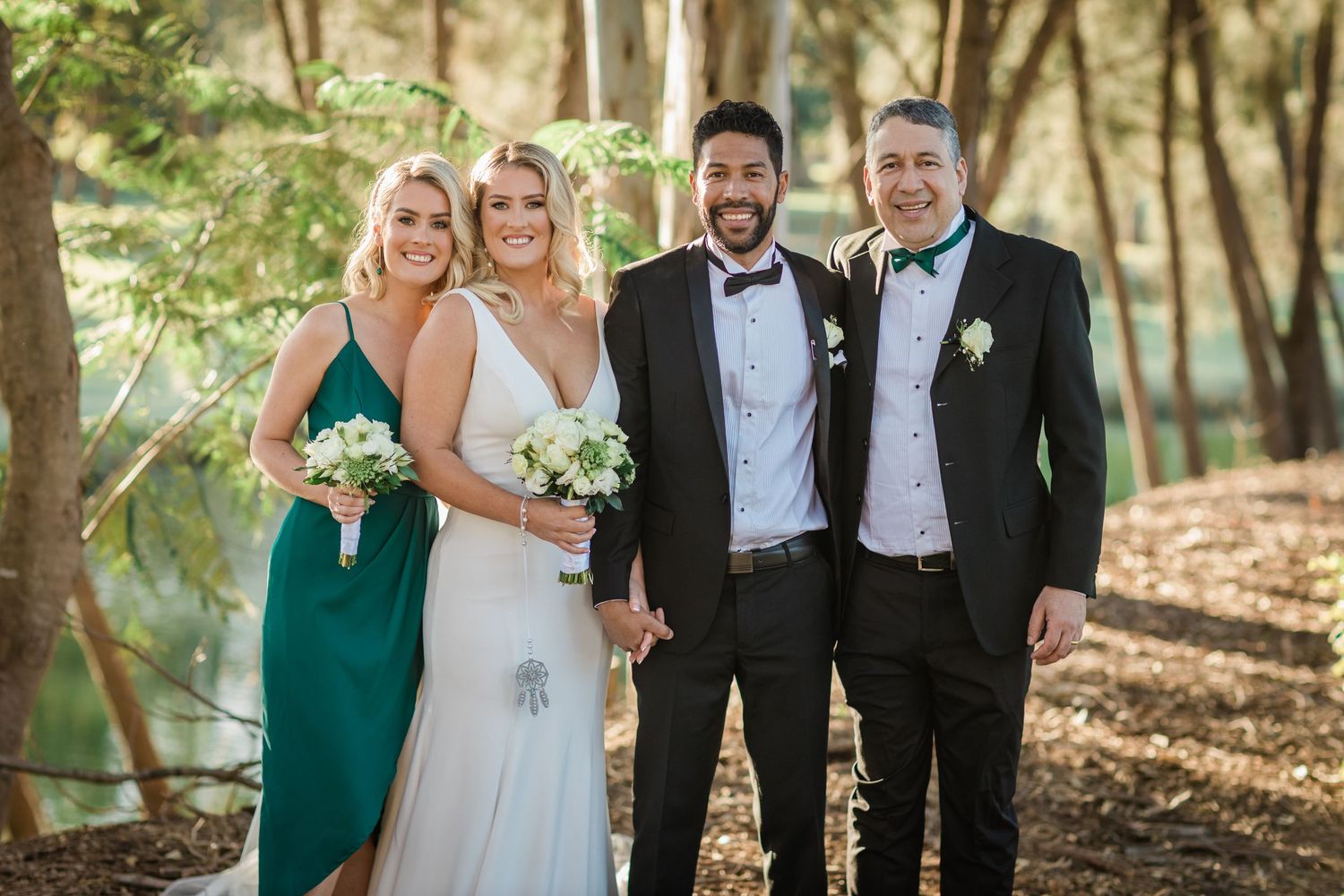Wedding party poses together in formal attire among trees and natural scenery. Surfers Paradise Golf Club wedding.