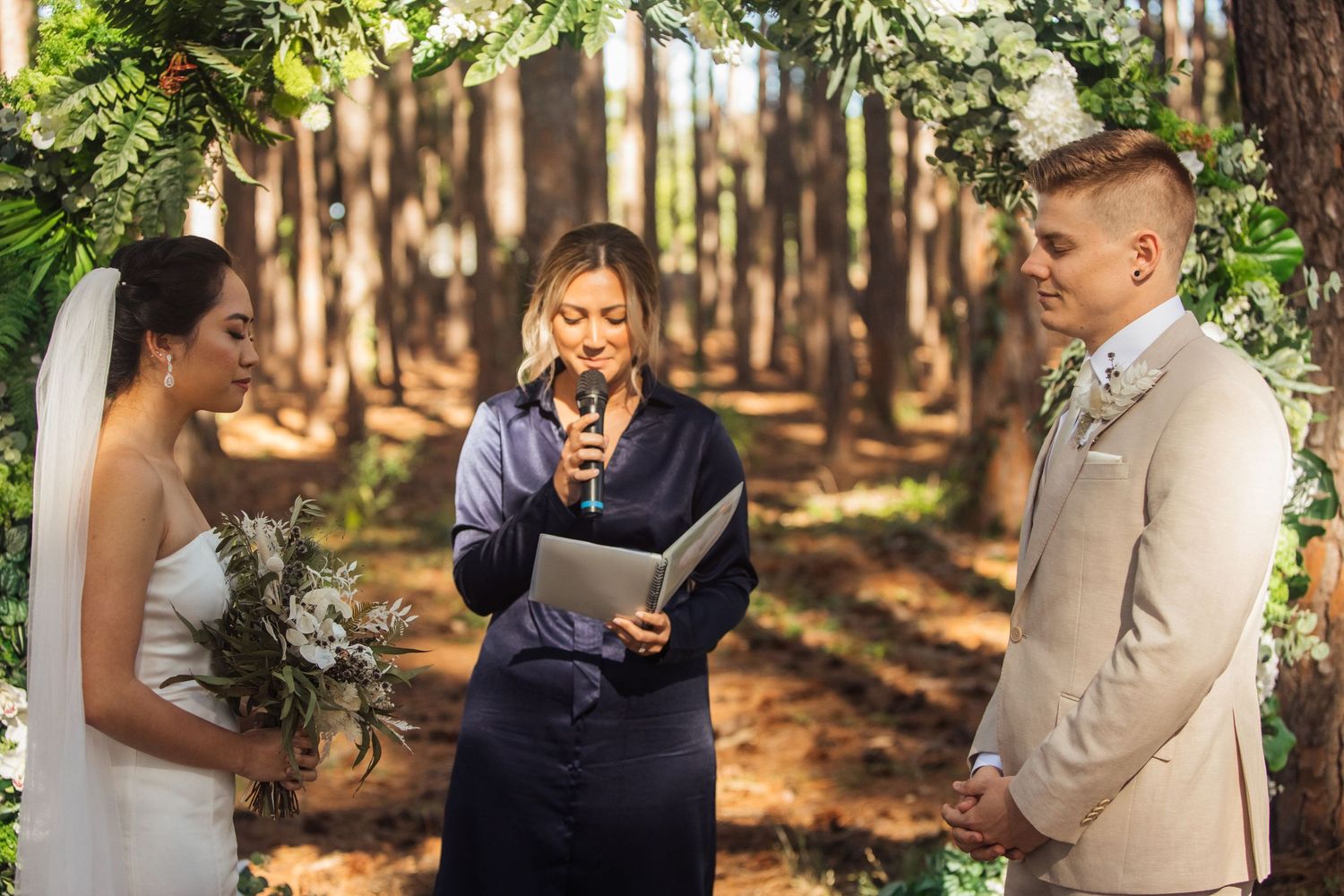 Wedding party gathered in a lush forest setting with natural greenery and sunlight.pizzey park wedding Gold Coast