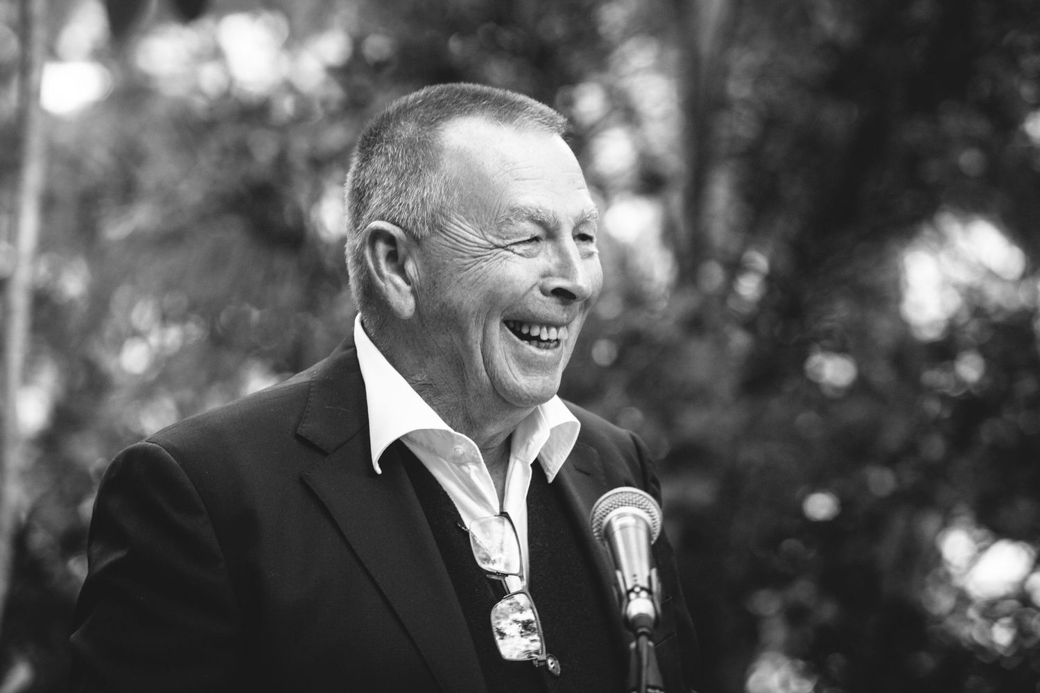 Black and white candid shots of guests enjoying speeches at an outdoor event.DIY wedding Gold Coast elopement photographer Gold Coast
