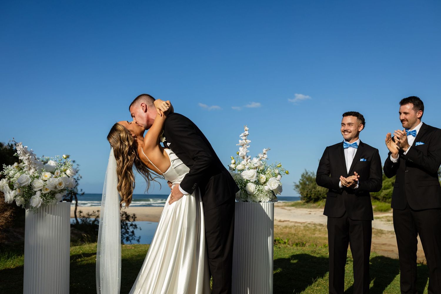 Outdoor beach wedding ceremony with ocean backdrop and clear blue skies.beach wedding currumbin surf club wedding