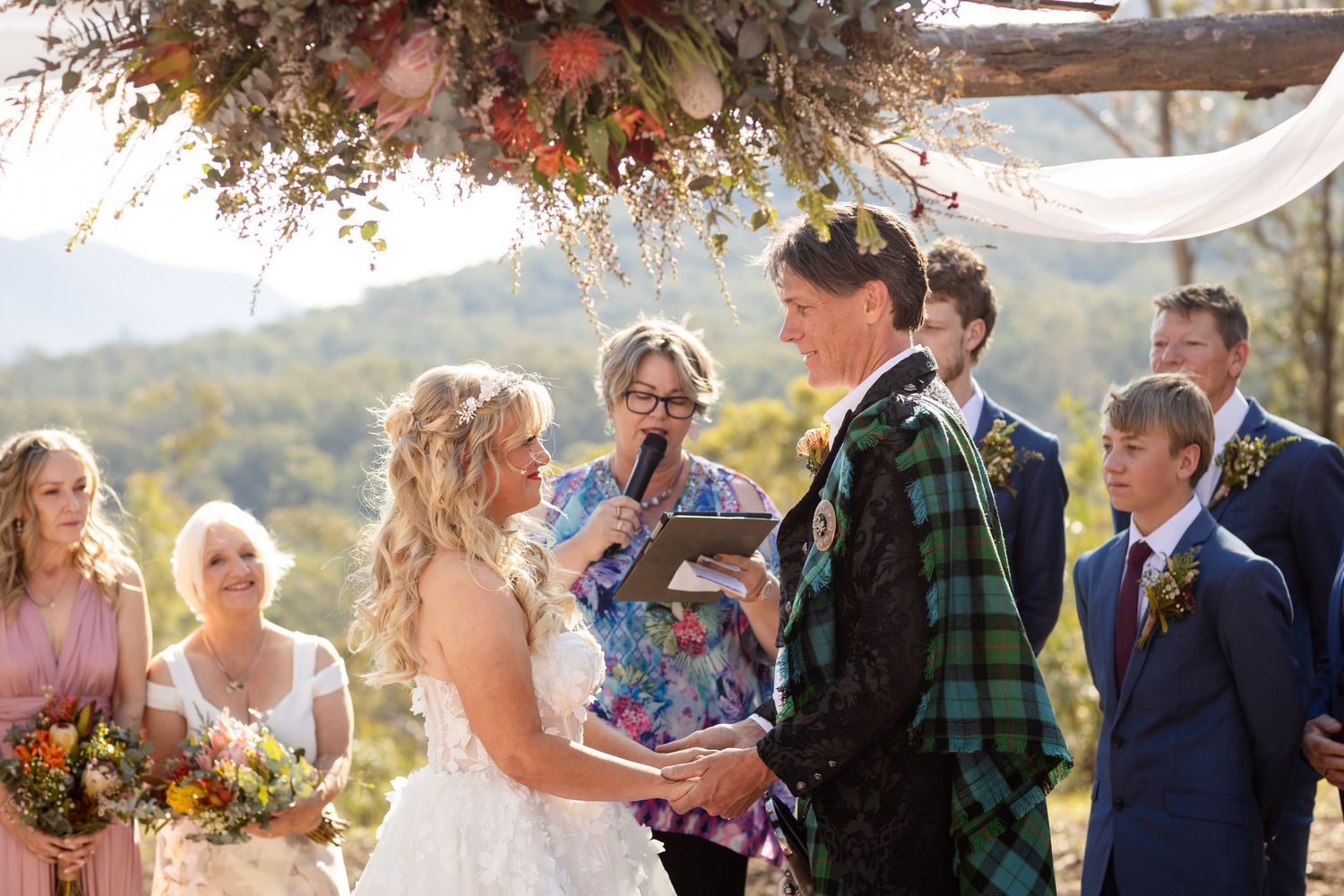 Wedding ceremony taking place in scenic mountain setting during autumn.Gold Coast wedding photographer