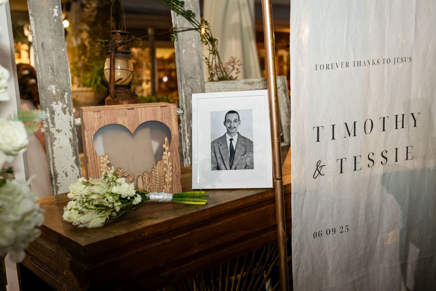 Wedding signage and decorative frames displayed on rustic wooden surface.Currumbin Valley wedding photography Gold Coast