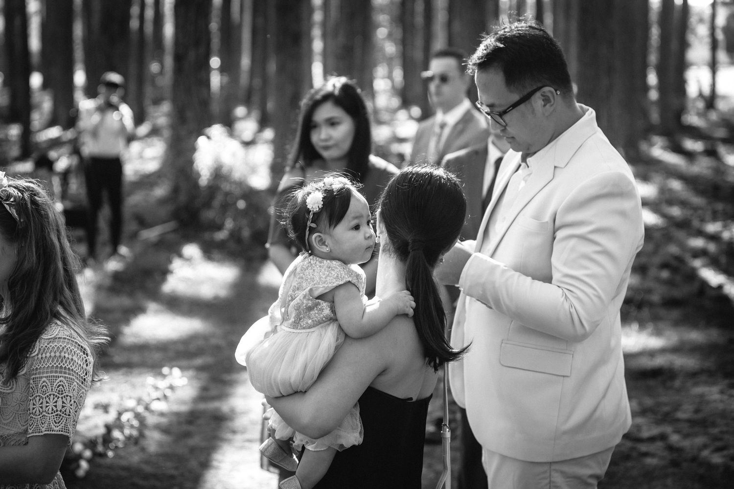 Tender moment during a forest wedding ceremony with soft black and white tones.pizzey park wedding Gold Coast