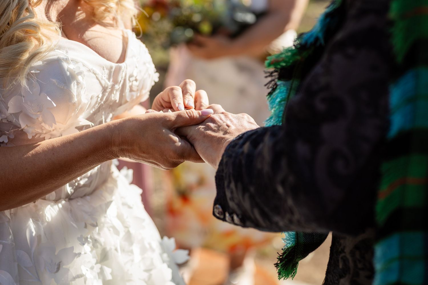 Close-up of hands during wedding ring exchange ceremony outdoors.Gold Coast wedding photographer