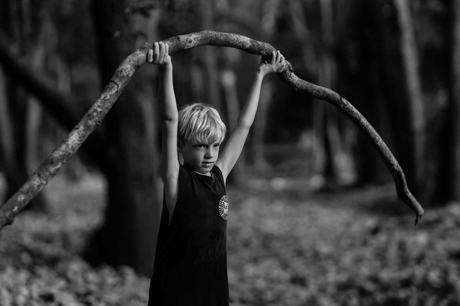 Black and white portrait of children playing in a wooded setting.Gold Coast candid family photographer.