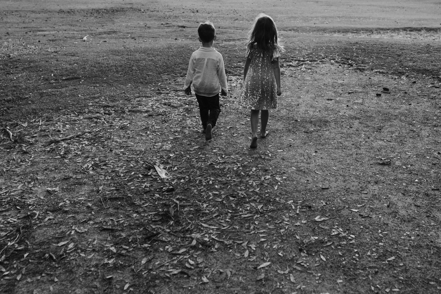 People walking together on a path in black and white.Gold Coast candid family photographer. Cabarita headland