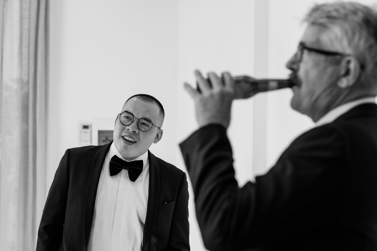 Formal preparations in bright white room with bow ties and formal wear.
