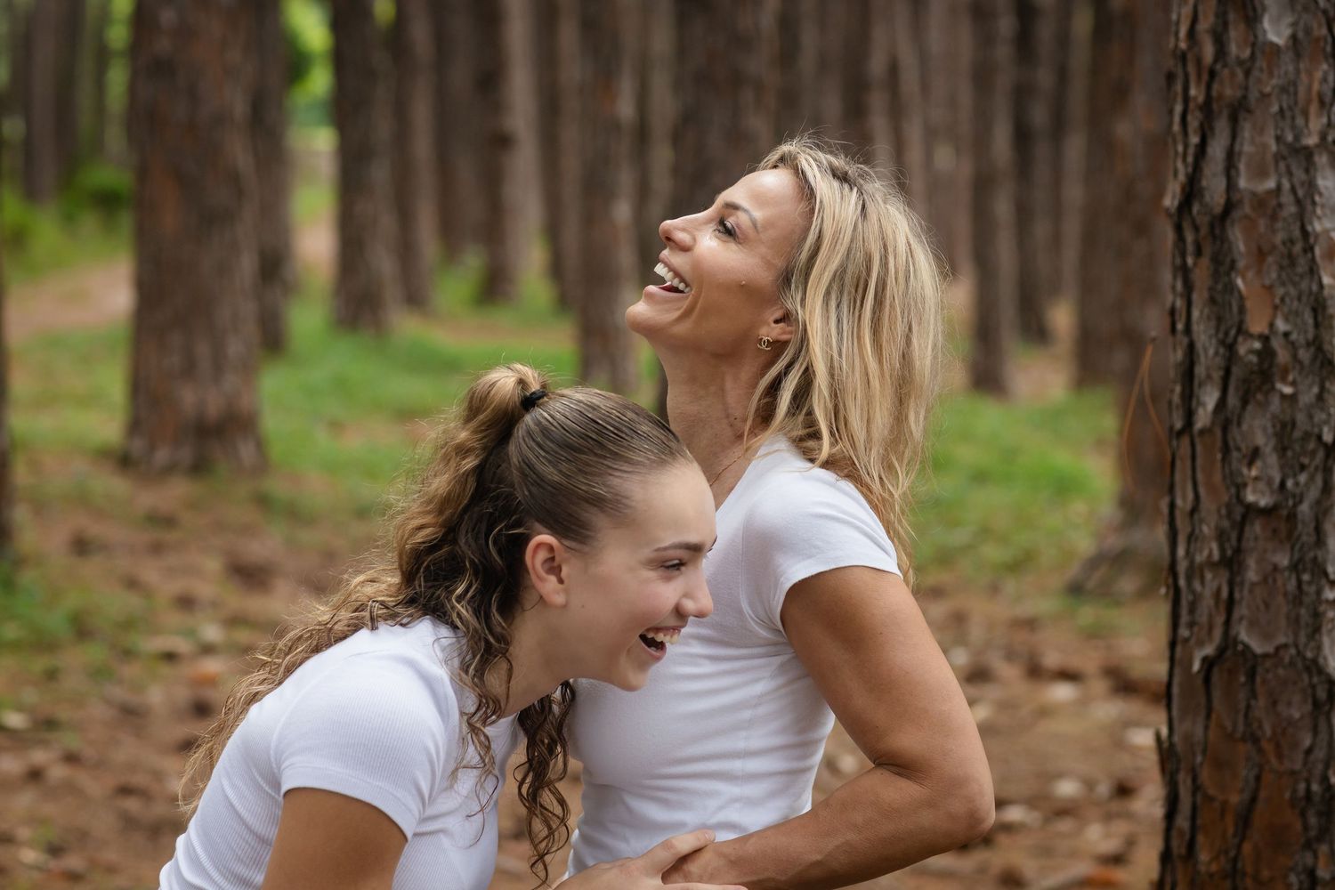 Candid moments of laughter and connection captured in a sunlit forest setting.Pizzey park family photos. Gold Coast