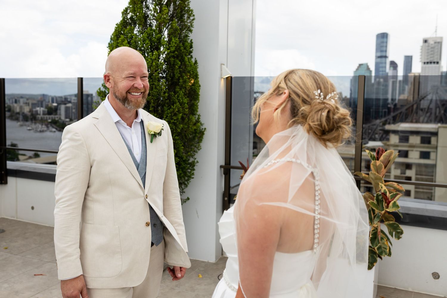 Rooftop wedding venue with city skyline views and greenery.