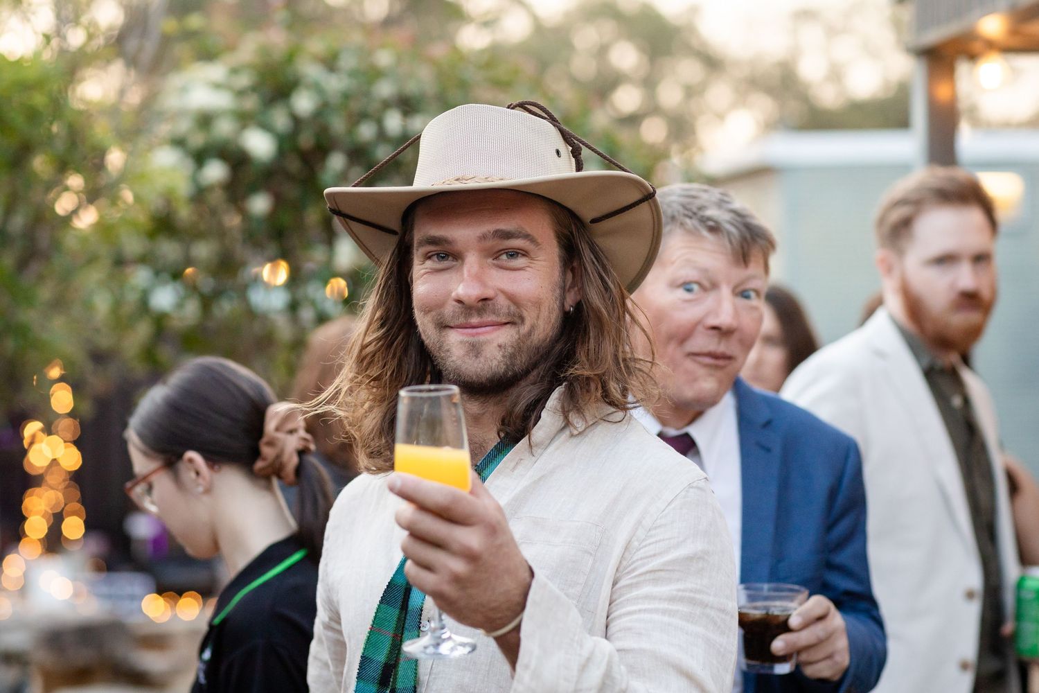 Guests mingling and socializing during an outdoor evening event.