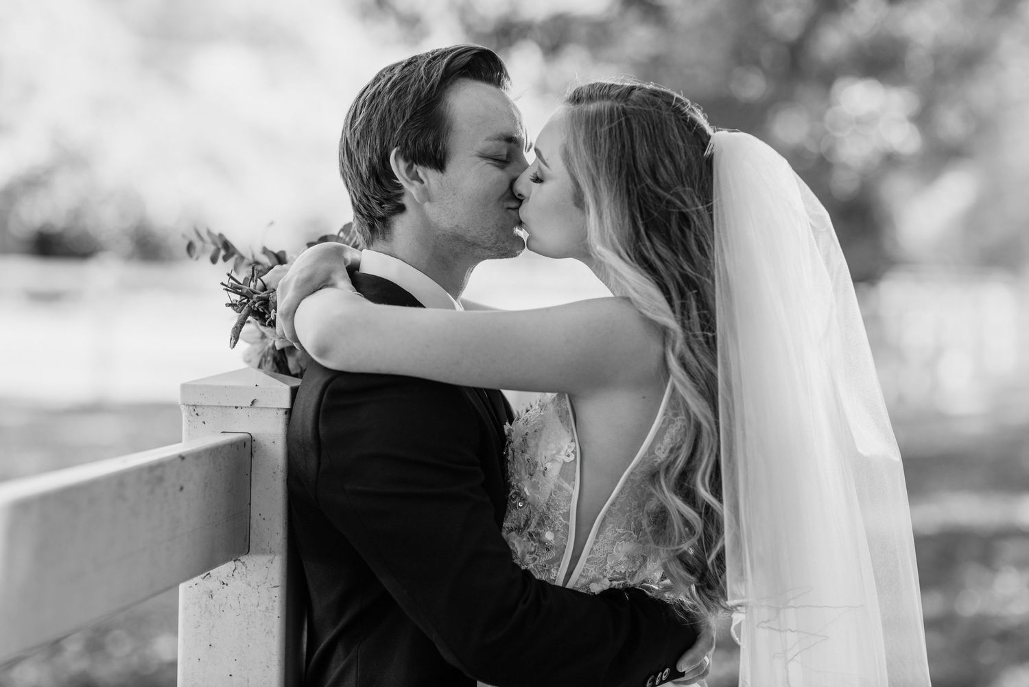 A romantic black and white wedding photo collage showing tender moments between newlyweds in outdoor settings.
