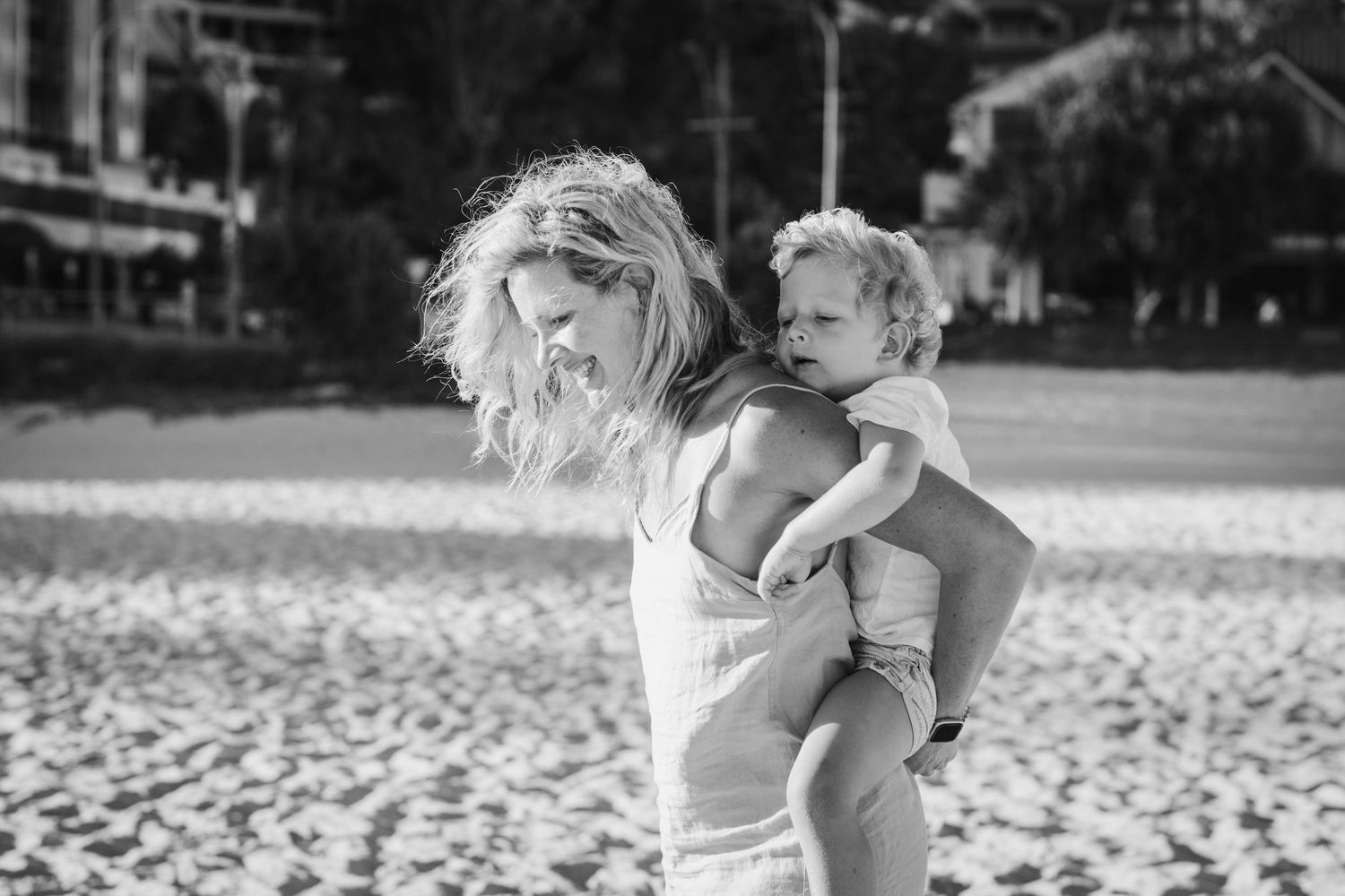 Loving embrace captured during a beach photography session.Gold Coast candid family photographer.