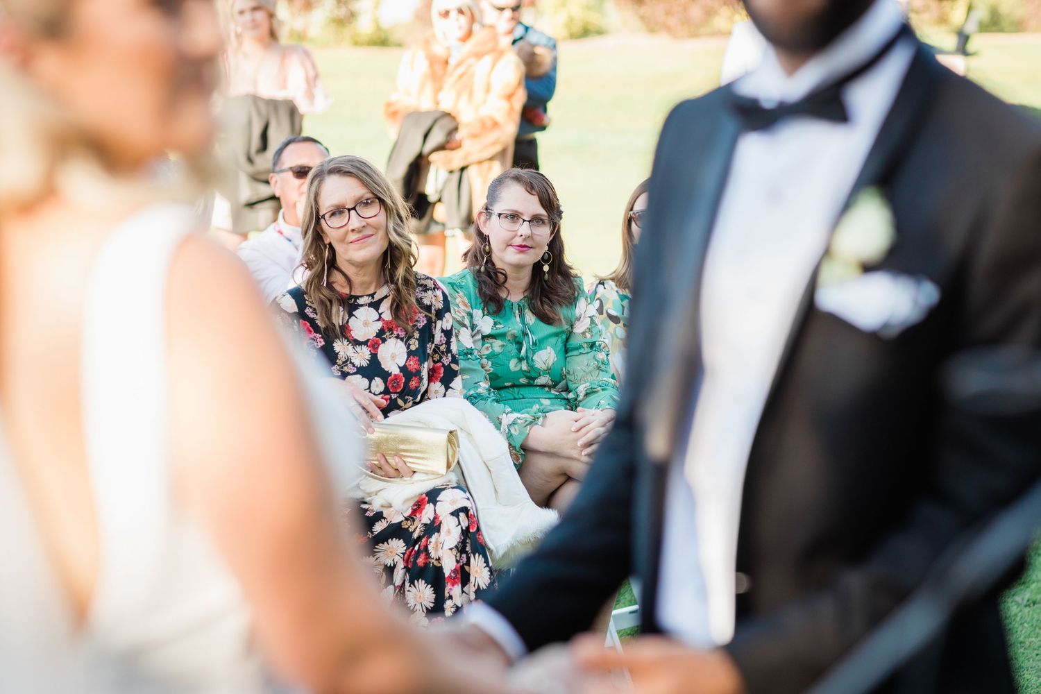 Wedding guests seated outdoors during a sunny afternoon ceremony. Surfers Paradise Golf Club wedding.