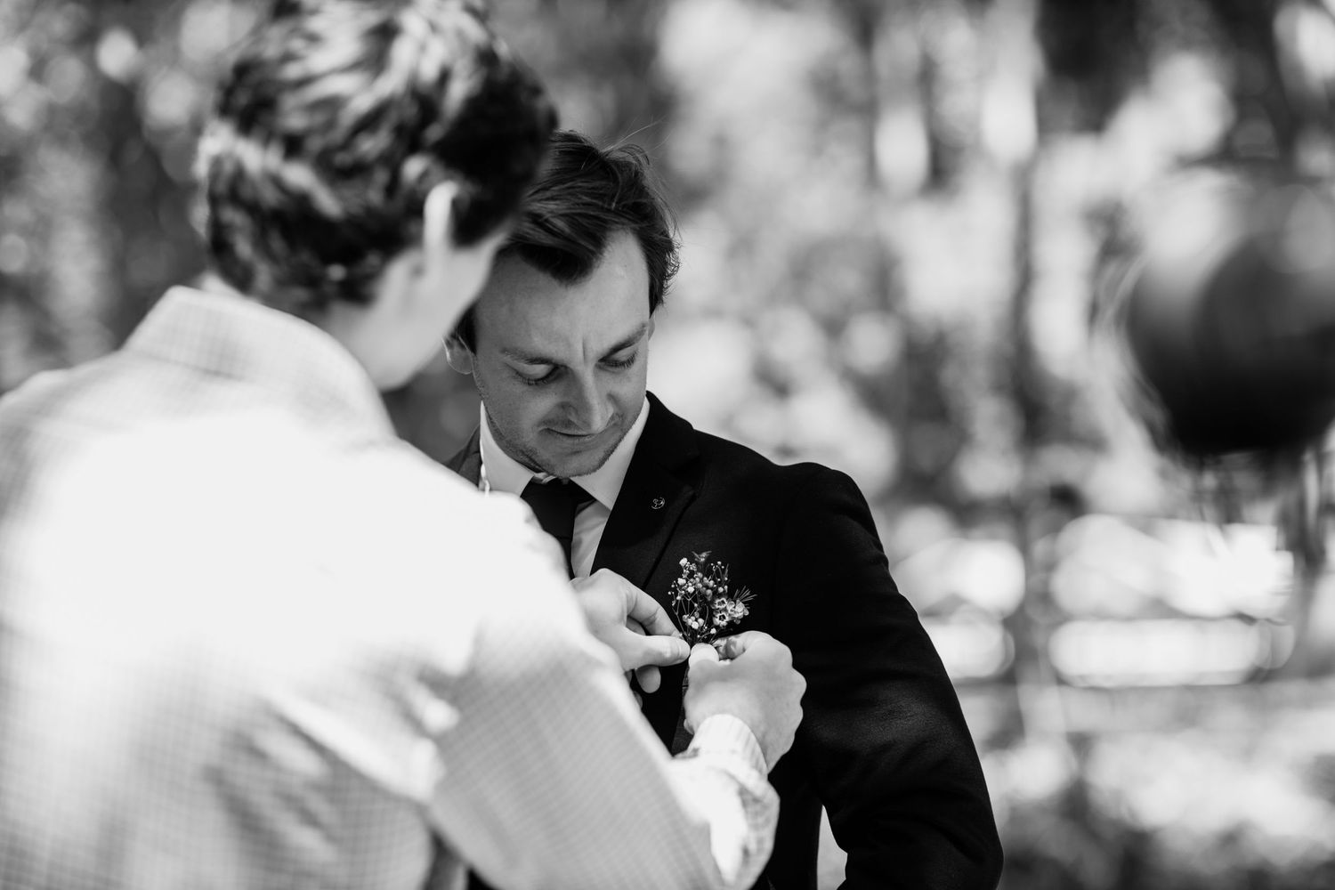 Black and white photo of wedding ceremony preparations in natural outdoor setting.Currumbin Valley wedding photography Gold Coast