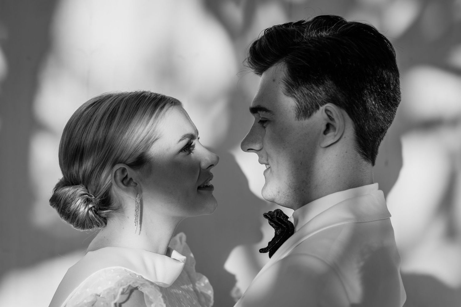 Black and white close-up portraits of newlyweds sharing intimate moments.