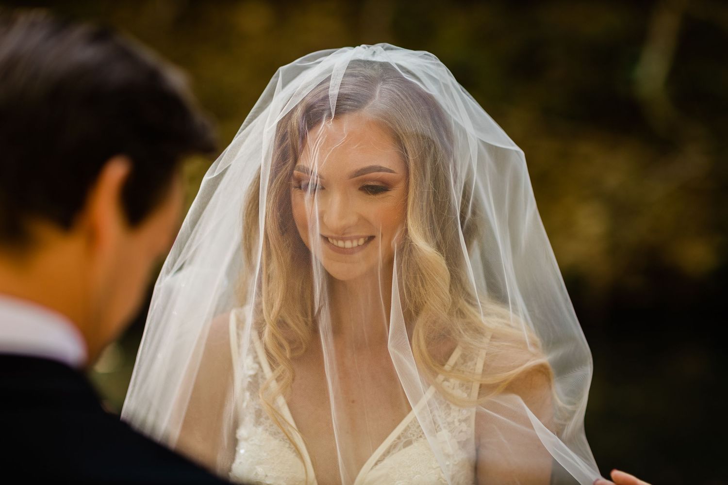 Bride's veil flows gracefully in the golden sunlight during an outdoor forest wedding.Currumbin Valley wedding photography Gold Coast