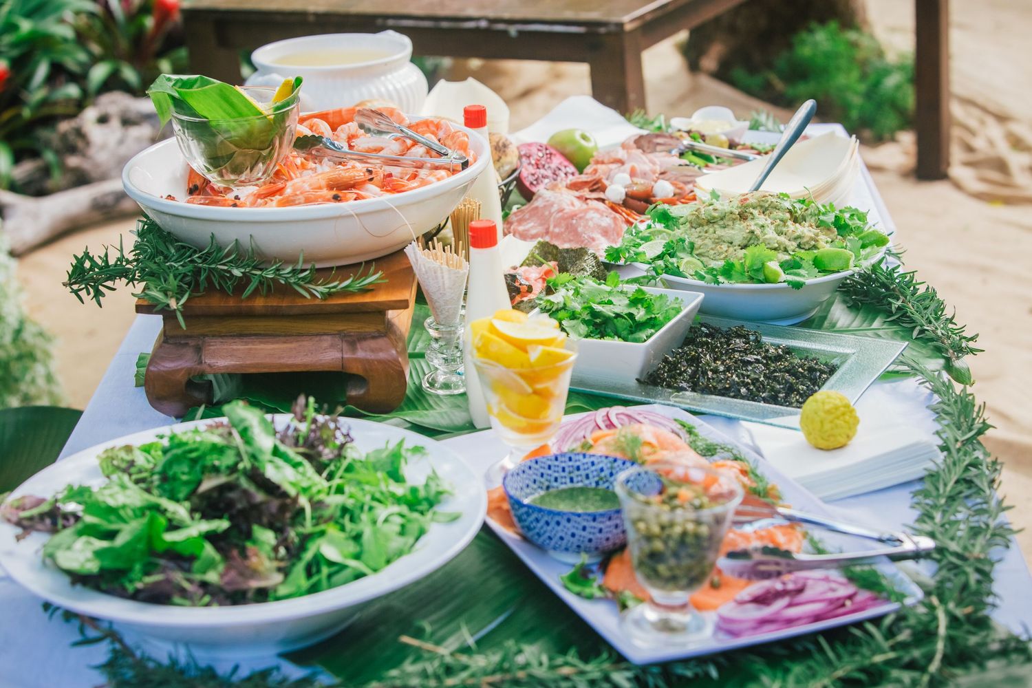 Elegant table settings with fresh salads and garnishes at an outdoor garden party.DIY wedding Gold Coast elopement photographer Gold Coast