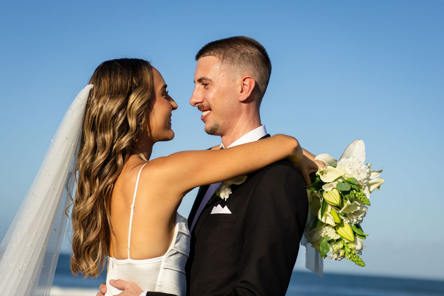 Close-up shots of a couple sharing romantic moments at their beach wedding.beach wedding currumbin surf club wedding