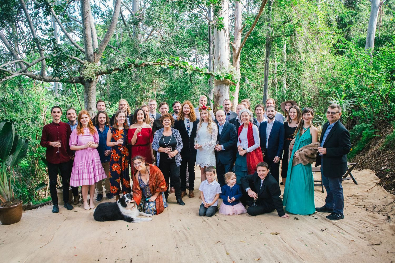 Large group wedding photo of guests and wedding party inDIY wedding Gold Coast elopement photographer Gold Coast outdoor garden setting.