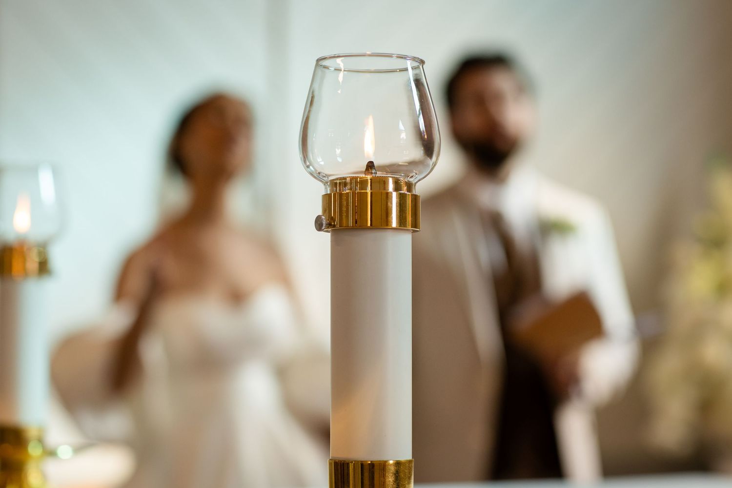 Soft focus wedding ceremony details with wine glasses and decorative elements in foreground.The barrow restaurant mount Nathan wedding